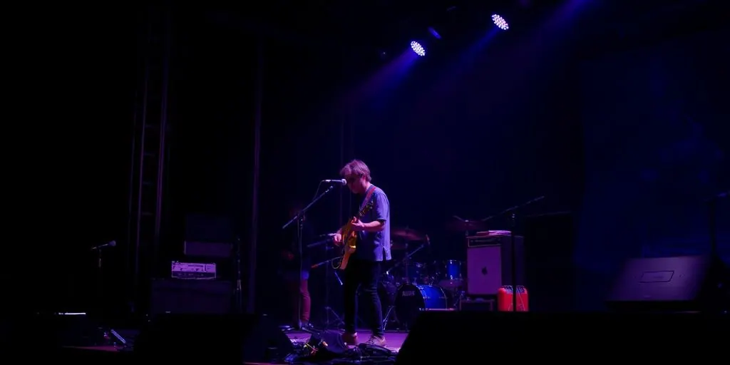 Musician performing on stage with equipment.